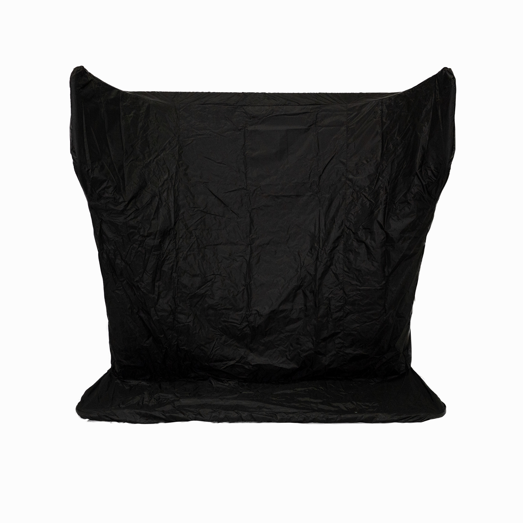 A large, black, crumpled fabric backdrop stands against a white background.