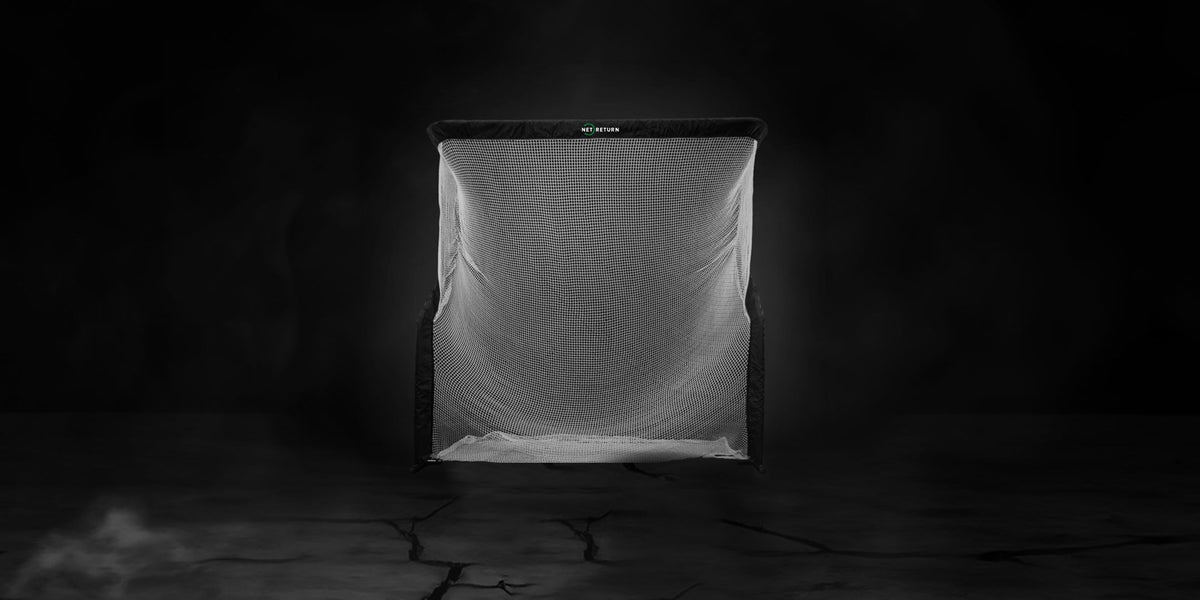A soccer goal net in a dimly lit setting on a cracked, dark surface.